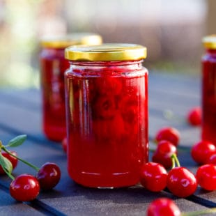 Tart cherry jam in small clear jars