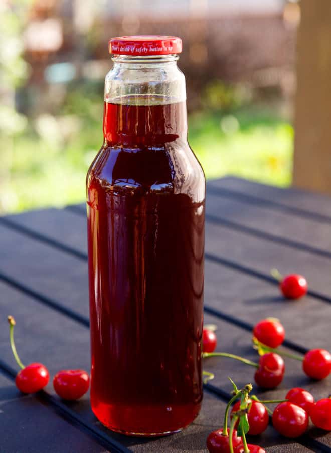 Sour cherry concentrate in 1 litre bottles on a table