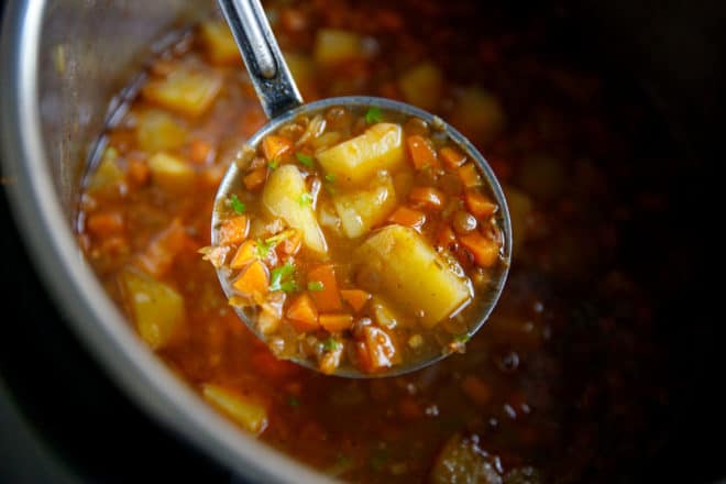 a ladle with Instant pot lentil potato soup 