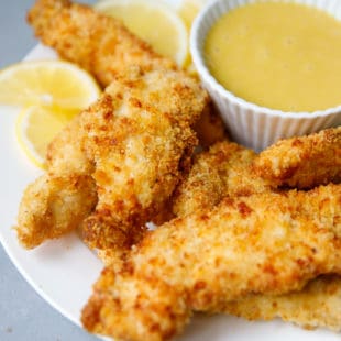 Air fryer chicken tenders on a white ceramic plate
