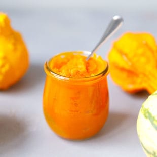 Homemade pumpkin puree in a weck jar with a spoon in it