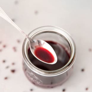 A jar with homemade elderberry syrup