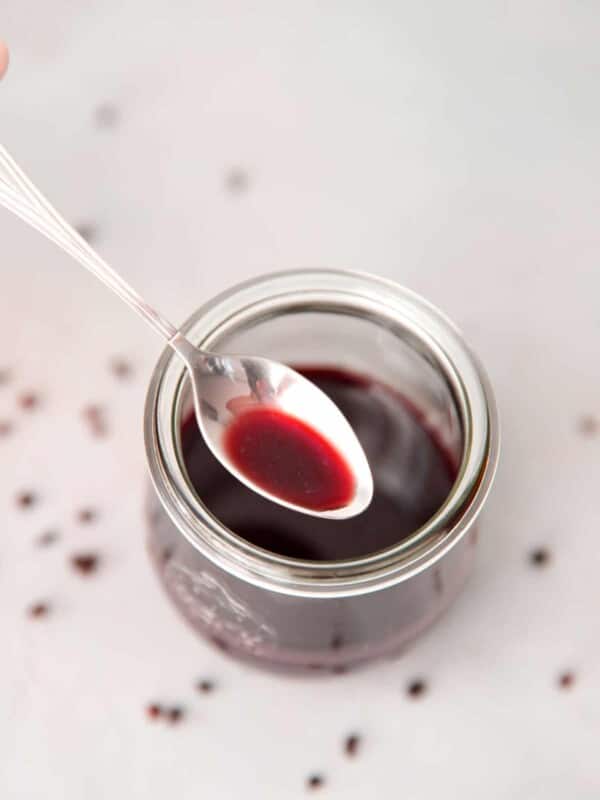 A jar with homemade elderberry syrup