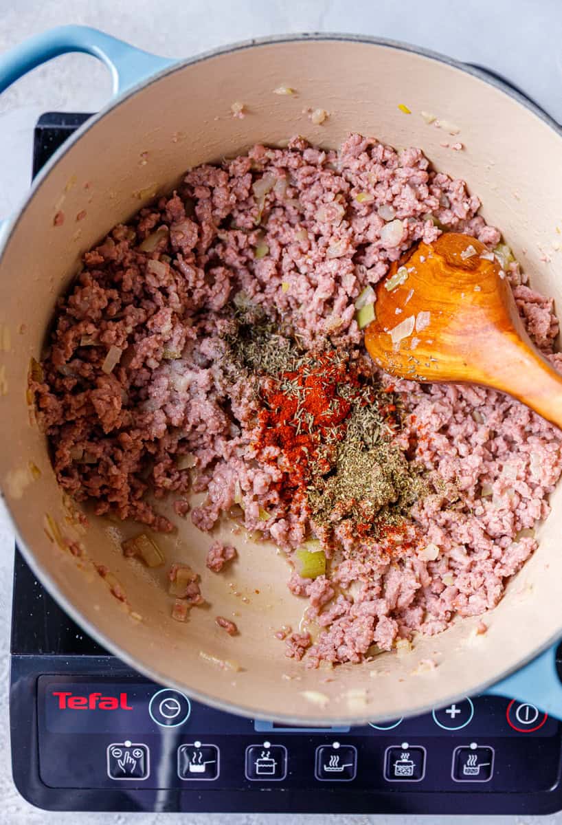 Cooked ground beef, onion and garlic and seasoning in a Dutch oven