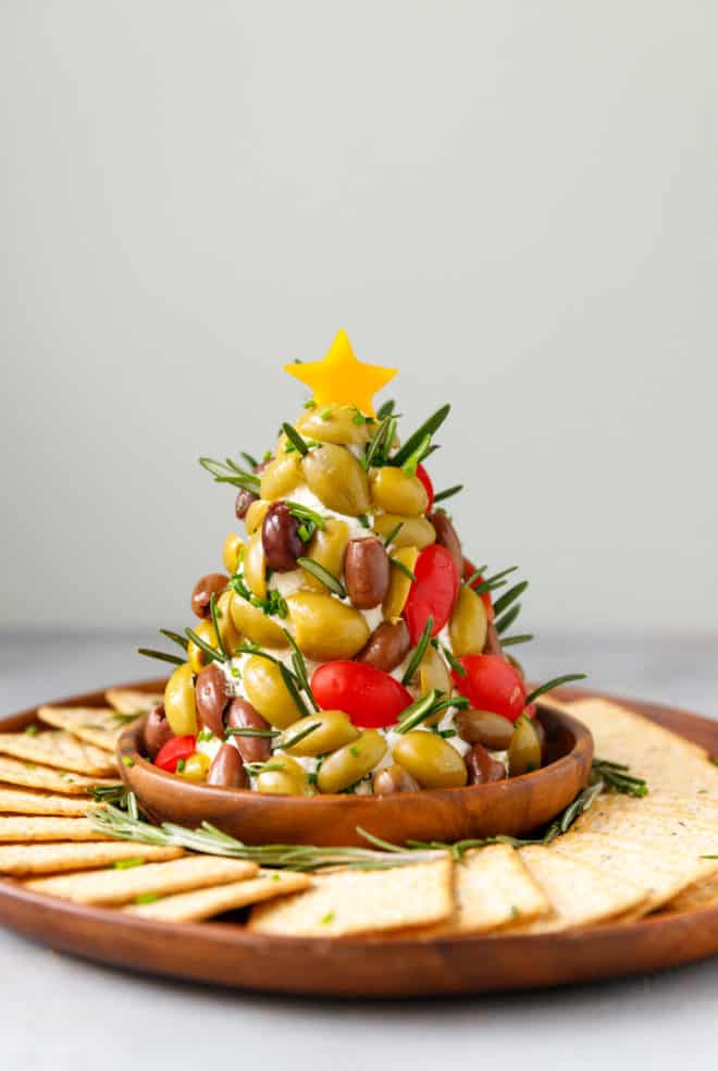Christnas tree cheese ball on a platter with crackers