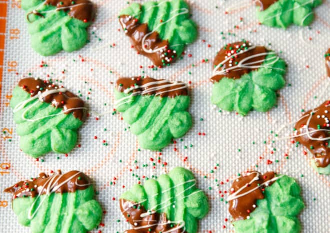 Green Christmas tree shaped Spritz cookies on a Silpat mat