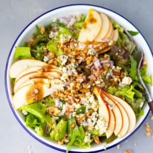Apple walnut salad in a white bowl
