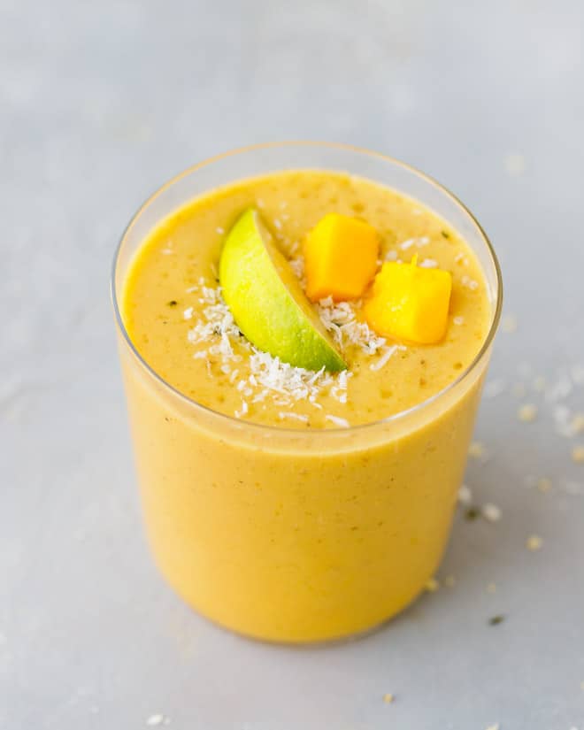 An 8 oz glass filled with mango smoothie