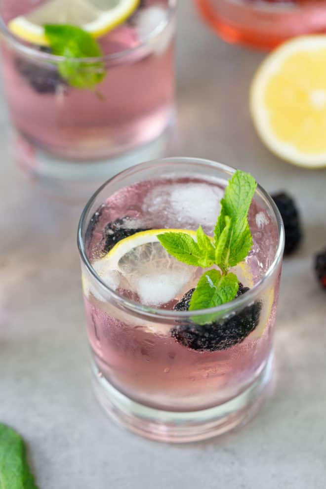 A glass with pink gin tonic cocktail