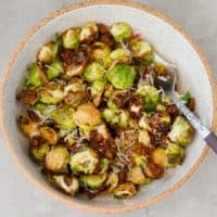 A bowl with Air Fryer Brussels sprouts topped with Parmesan