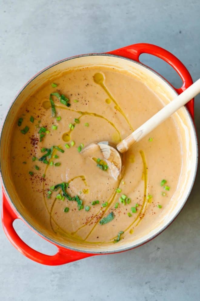 A red Dutch oven filled with Roasted Eggplant Soup