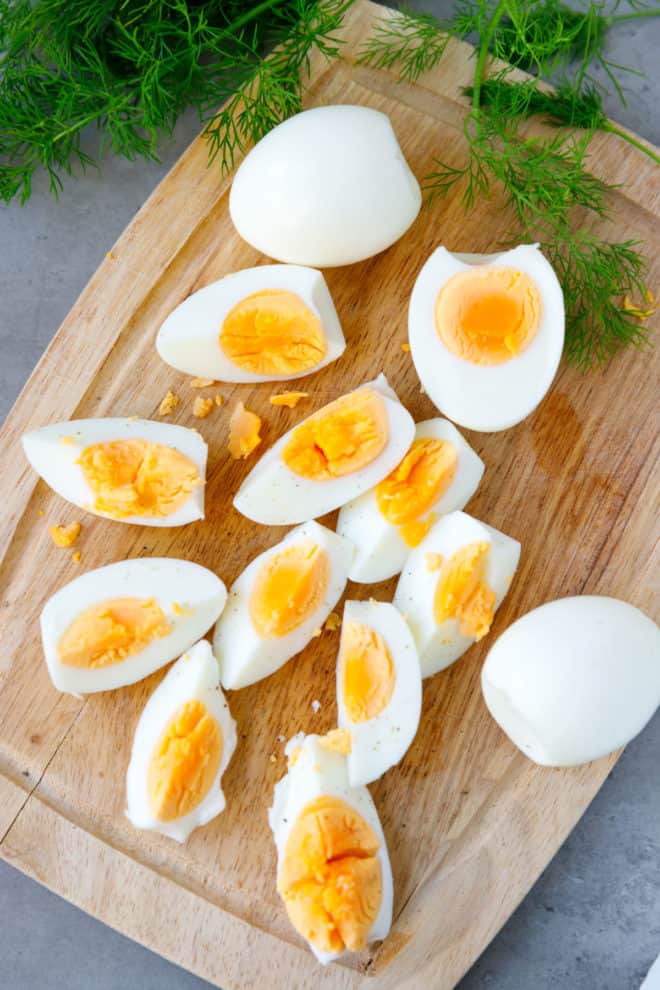 Huevos cocidos en una freidora de aire sobre una tabla para cortar