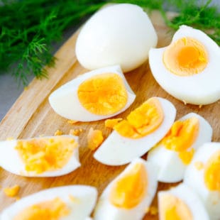 Hard boiled eggs made in the Air fryer cut on a cutting board
