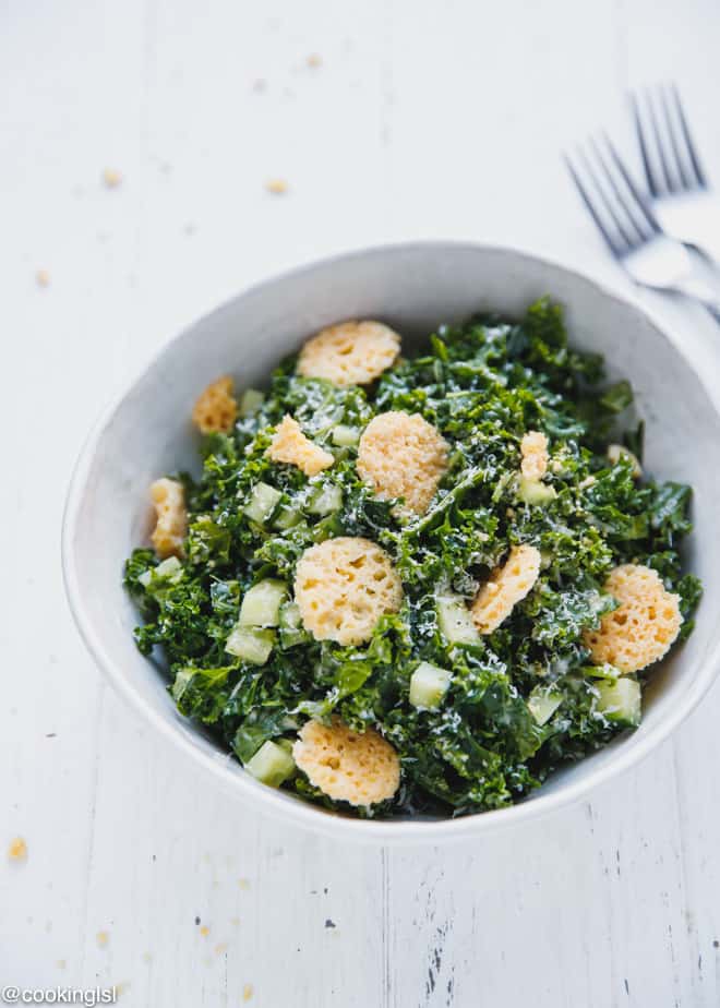 A bowl with Kale Caesar salad and Parmesan croutons