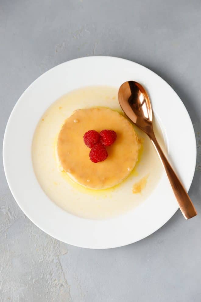 Keto Flan on a white ceramic plate with a spoon