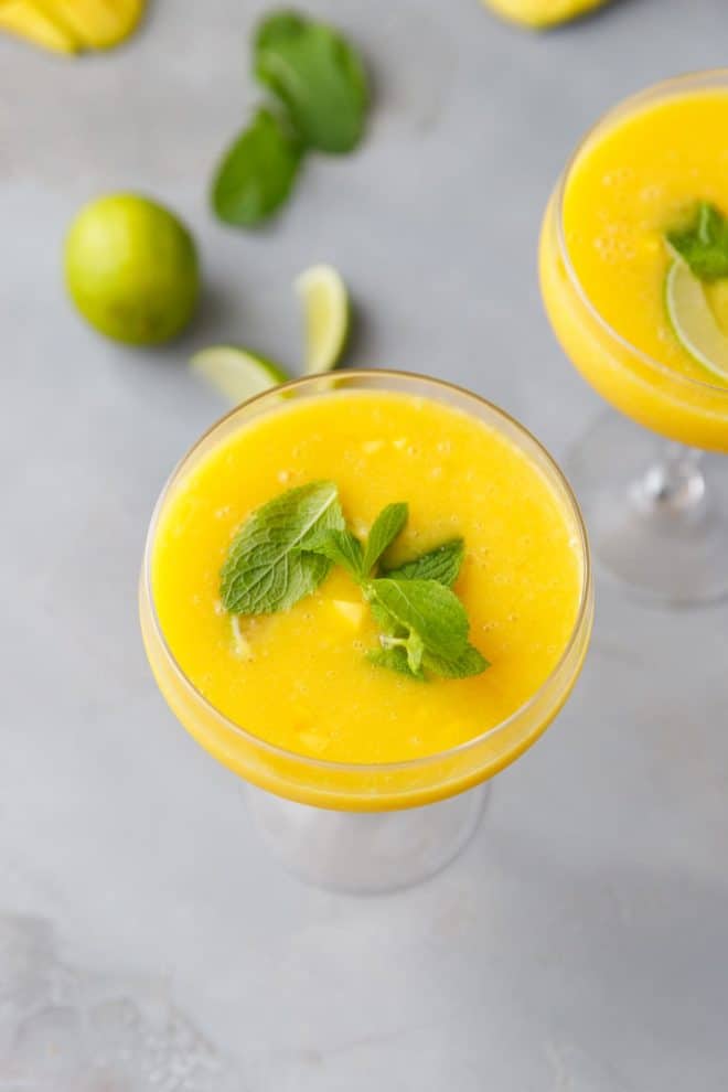 Mango daiquiri in a cocktail glass topped with fresh mint