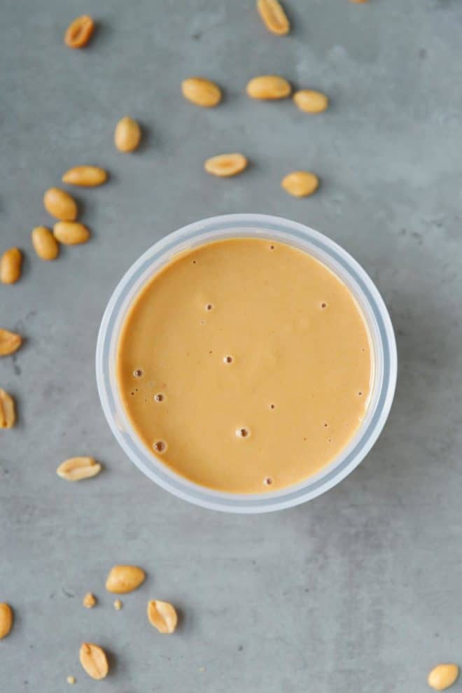 Homemade peanut butter in a clear plastic container