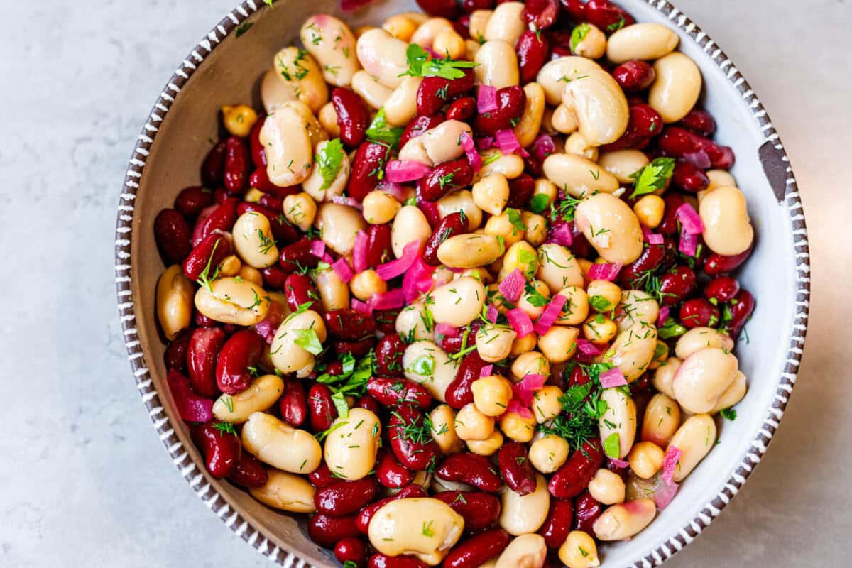 Three bean salad with kidney beans, cannellini, and chickpeas tossed in olive oil and vinegar dressing