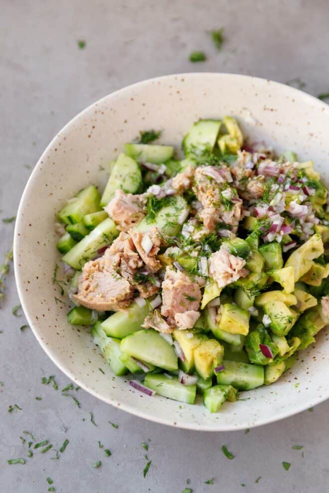 A bowl with avocado tuna cucumber salad