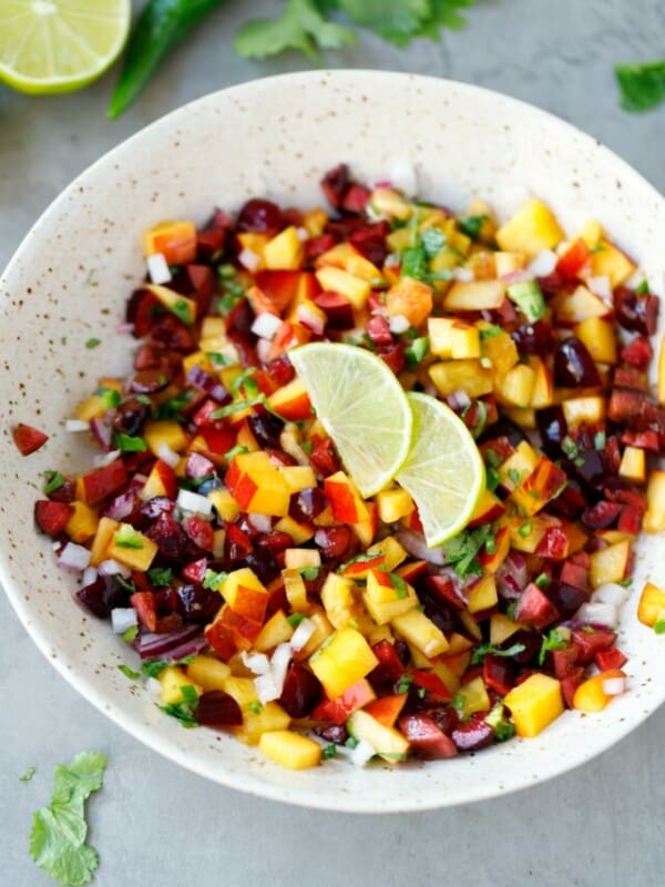 Nectarine salsa topped with lime slices in a bowl