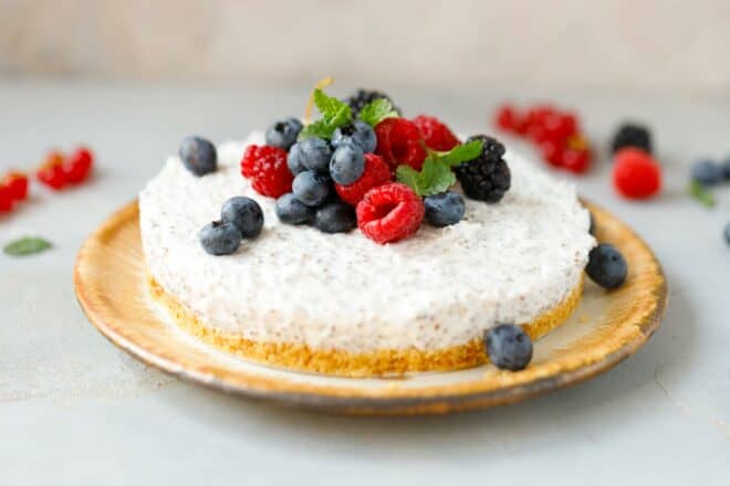 Dairy-free chia cheesecake on a plate, topped with berries