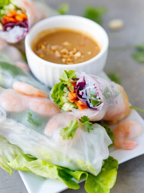 A plate with fresh shrimp spring rolls and peanut sauce