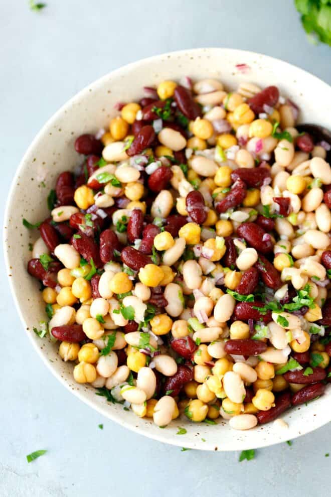 A speckled bowl filled with three bean salad