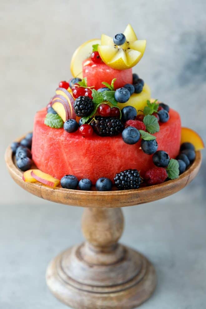Watermelon fruit cake on a wooden cake stand