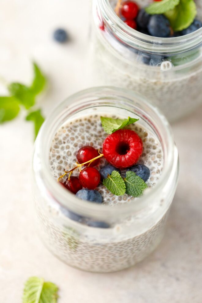 Basic chia pudding in a jar, topped with raspberry and blueberries
