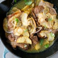 Pork chops with apples in an a cast iron pan