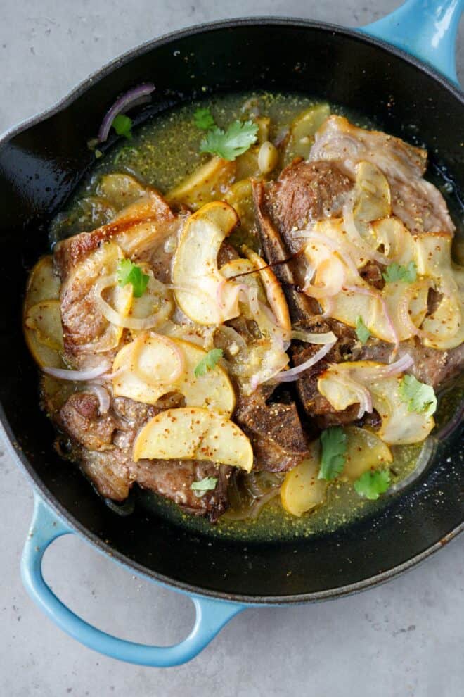 Pork chops with apples in an a cast iron pan