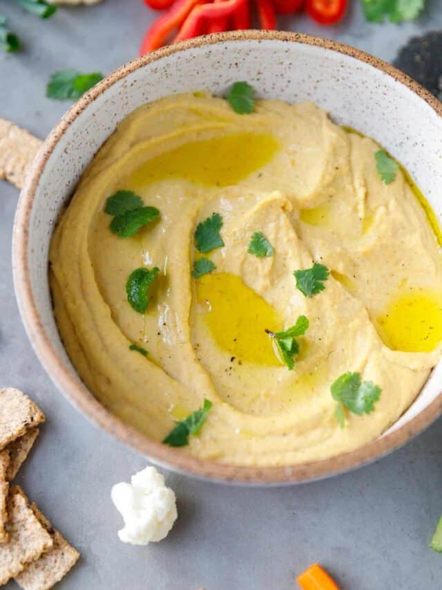 Red lentil dip in a speckled bowl