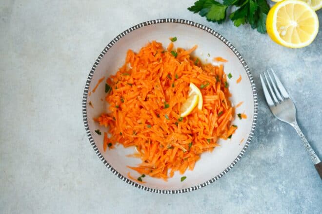 Shredded carrot salad with light dressing in a bowl