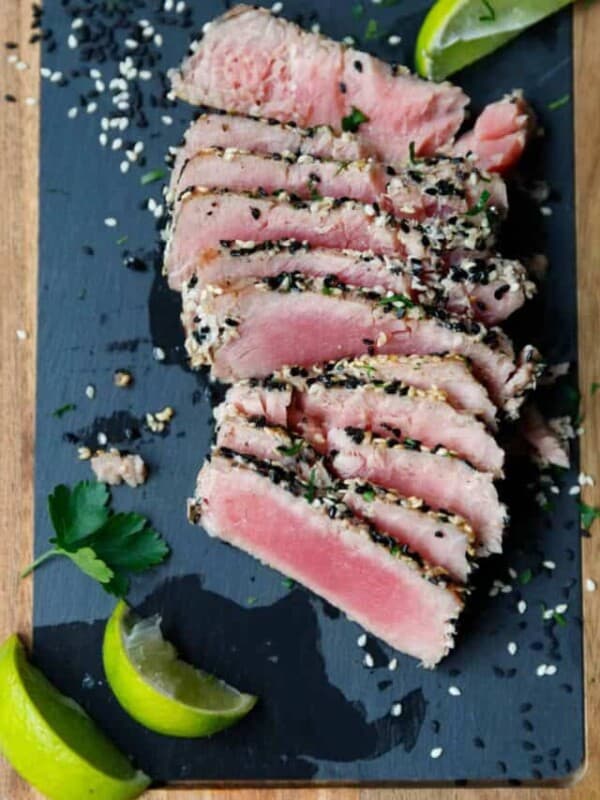 Ahi tuna steak sliced on a cutting board