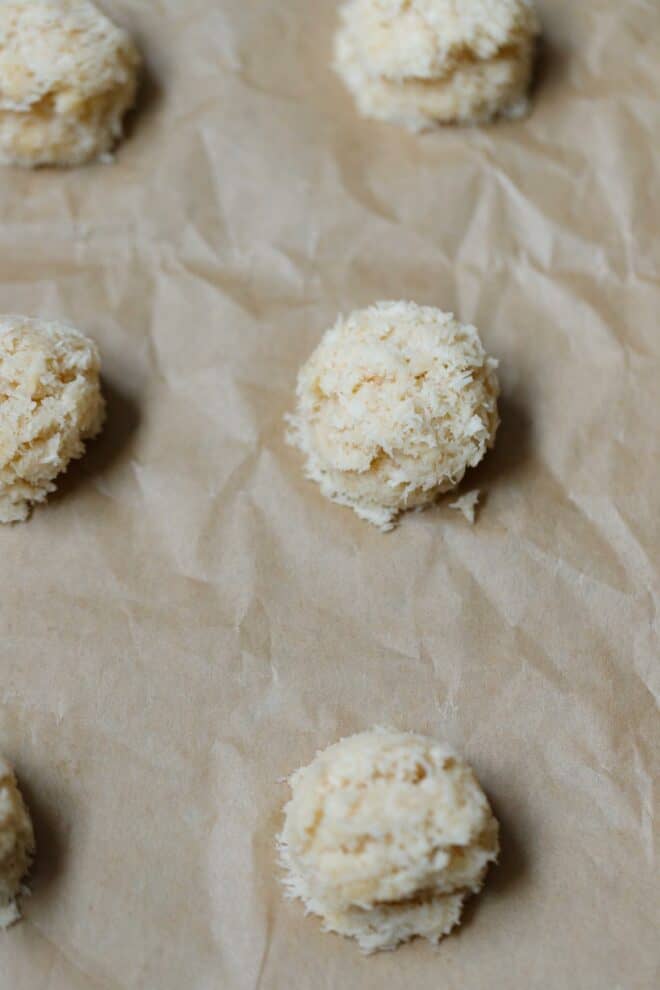 Raw coconut macaroons on a baking sheet
