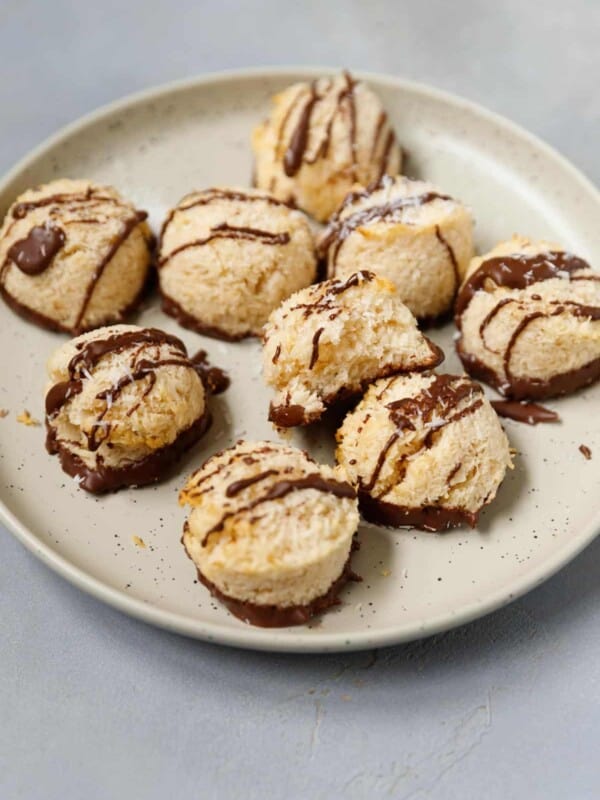 Gluten Free Coconut Macaroons drizzled with chocolate on a speckled plate