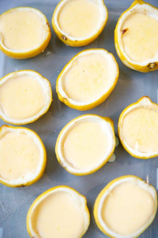 Lemon Creme Brûlée inside lemon shells on a baking dish