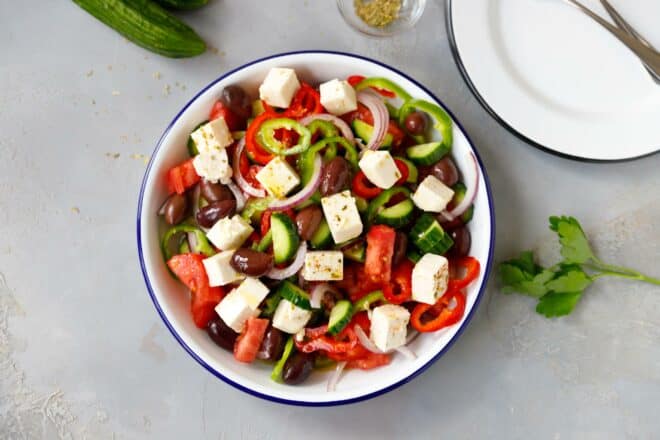 White bowl with Greek Salad on a table