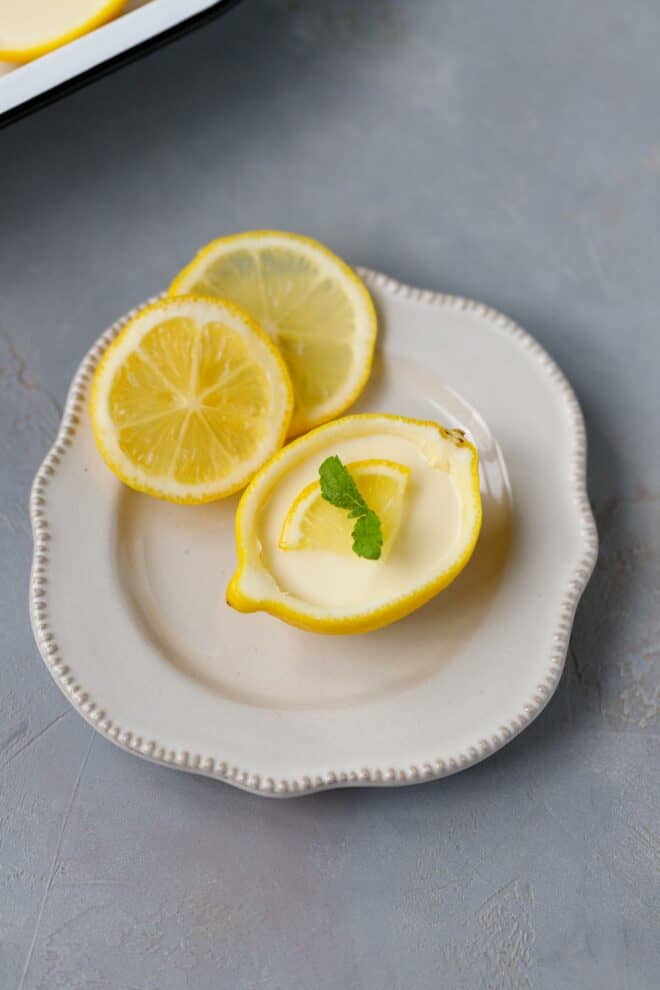 Lemon posset in lemon cups/bowls on a plate