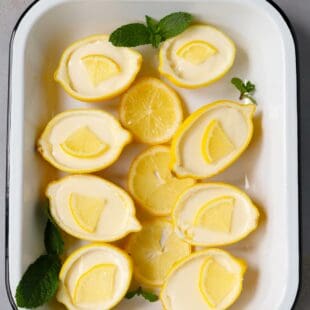 Lemon Posset in lemon shells on a white tray