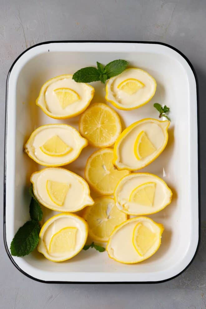 Lemon Posset in lemon shells on a white tray
