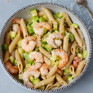 A bowl with zucchini and shrimp brown pasta