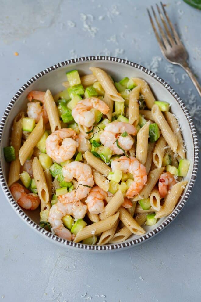 A bowl with zucchini and shrimp brown pasta
