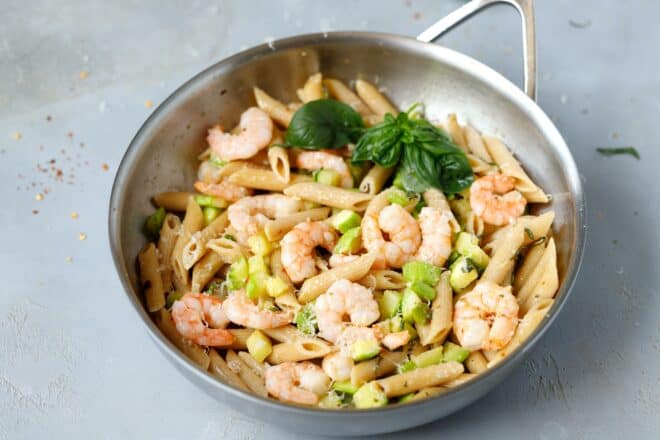 A pan with zucchini shrimp pasta