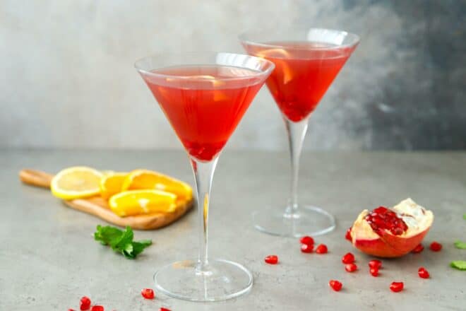 Two glasses with pomegranate martini at a tabletop