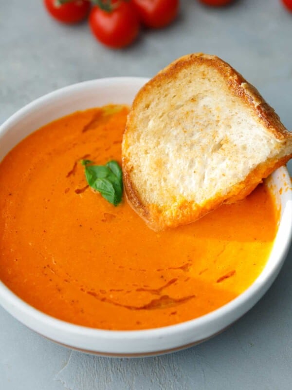 A white bowl with creamy roasted tomato soup