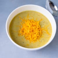 White bowl with cheddar broccoli instant pot soup