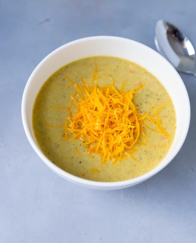 A white ceramic bowl with Instant Pot broccoli and cheddar soup
