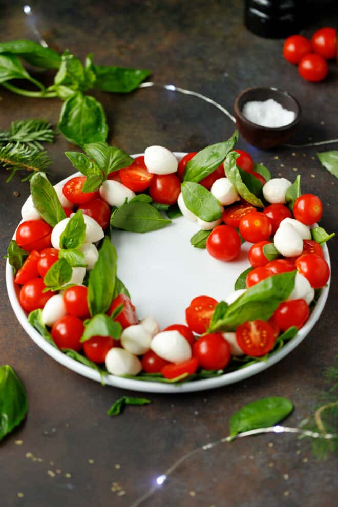 A white platter with Caprese Christmas Wreath