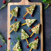 Cheese Wedges Covered in herbs with pretzel stick inserted to make them look like Christmas tree